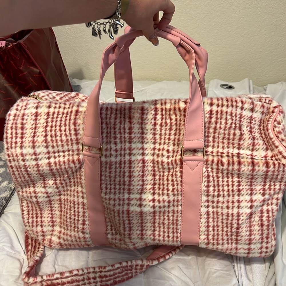 Pink and white duffle bag